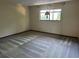 Spacious bedroom with neutral walls, carpet, and a window bringing in natural light at 96 Old Barn Trl, Ormond Beach, FL 32174