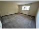 Spacious bedroom with neutral walls, carpet, and a window bringing in natural light at 96 Old Barn Trl, Ormond Beach, FL 32174