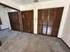 Bright bedroom featuring classic bi-fold closet doors for ample storage and neutral carpeting at 96 Old Barn Trl, Ormond Beach, FL 32174