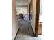 Hallway with carpet floors and wood trim offering access to various rooms at 96 Old Barn Trl, Ormond Beach, FL 32174