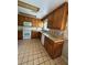 Functional kitchen equipped with wooden cabinets and tile flooring for easy maintenance at 96 Old Barn Trl, Ormond Beach, FL 32174