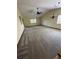 Open living room with vaulted ceilings and neutral carpeting, awaiting your personal touch at 96 Old Barn Trl, Ormond Beach, FL 32174