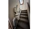 Stair lift offers accessibility on carpeted stairs with wooden railing on the side at 96 Old Barn Trl, Ormond Beach, FL 32174