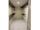Spacious walk-in closet with shelving and tile floor offers plenty of storage space at 96 Old Barn Trl, Ormond Beach, FL 32174