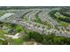 Aerial view captures a golf course community, showing residences with neatly manicured yards and a lush green landscape at 978 Victoria Hills S Dr, Deland, FL 32724