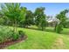 Professionally landscaped backyard with green lawn and mature trees overlooking a golf course at 978 Victoria Hills S Dr, Deland, FL 32724
