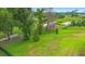 Well-maintained backyard with lush green grass, mature trees, and partial fencing overlooking a golf course at 978 Victoria Hills S Dr, Deland, FL 32724