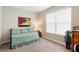 This bedroom provides a full size bed, a window, and simple decor at 978 Victoria Hills S Dr, Deland, FL 32724