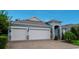 Beautiful home with a three-car garage, paver driveway, stone accents, and neat landscaping at 978 Victoria Hills S Dr, Deland, FL 32724