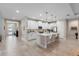 Spacious white kitchen featuring a large center island with seating, stainless steel appliances, and tile floors at 978 Victoria Hills S Dr, Deland, FL 32724