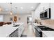 Beautiful kitchen with stainless steel appliances, white cabinets, a center island, and tile flooring at 978 Victoria Hills S Dr, Deland, FL 32724