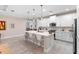 Bright white kitchen with a center island, pendant lighting, stainless steel appliances, and tile flooring at 978 Victoria Hills S Dr, Deland, FL 32724