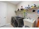 Laundry room featuring stainless steel washer and dryer with extra storage space at 978 Victoria Hills S Dr, Deland, FL 32724