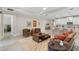 Comfortable seating arrangement in living room with beige tiling, leading to an open kitchen at 978 Victoria Hills S Dr, Deland, FL 32724