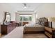 Bright main bedroom features a large window, tray ceiling, and neutral color palette at 978 Victoria Hills S Dr, Deland, FL 32724