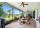 Outdoor entertaining area features screened lanai, grill and seating, with golf course view at 978 Victoria Hills S Dr, Deland, FL 32724
