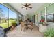 A covered patio features brick flooring, ceiling fans, and a beautiful outdoor view of the golf course at 978 Victoria Hills S Dr, Deland, FL 32724