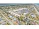 Wide aerial shot showcasing the surrounding neighborhood with commercial areas, houses, and waterfront views at 10 Lynnhurst Dr # 1050, Ormond Beach, FL 32176