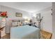 Comfortable bedroom with a plush bed, vibrant artwork, and an exercise bike for a healthy lifestyle at 10 Lynnhurst Dr # 1050, Ormond Beach, FL 32176