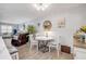 Cozy dining area featuring a round table, chairs with floral cushions, and decorative artwork on the wall at 10 Lynnhurst Dr # 1050, Ormond Beach, FL 32176