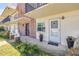 Close-up of condo entrance, potted flowers, and Lion statue flanking the entry at 10 Lynnhurst Dr # 1050, Ormond Beach, FL 32176
