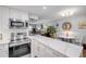 Modern kitchen offers quartz countertops, stainless steel appliances, and views into the adjacent living spaces at 10 Lynnhurst Dr # 1050, Ormond Beach, FL 32176