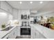 Contemporary kitchen showcasing quartz countertops, stainless steel appliances, and ample cabinet space at 10 Lynnhurst Dr # 1050, Ormond Beach, FL 32176