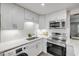 Stylish kitchen featuring stainless steel appliances, quartz countertops, white cabinets, and ample storage at 10 Lynnhurst Dr # 1050, Ormond Beach, FL 32176