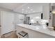 Modern kitchen boasts white cabinets, quartz countertops, stainless steel appliances, and in-unit laundry at 10 Lynnhurst Dr # 1050, Ormond Beach, FL 32176