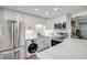 Well-lit kitchen with white cabinets, subway tile backsplash, quartz countertops, and stainless steel appliances at 10 Lynnhurst Dr # 1050, Ormond Beach, FL 32176