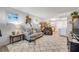 Open living room featuring new floors, comfortable furniture, and views of outside at 10 Lynnhurst Dr # 1050, Ormond Beach, FL 32176