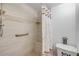 Tiled shower featuring a built-in bench and a grab bar for added safety and convenience at 10 Lynnhurst Dr # 1050, Ormond Beach, FL 32176