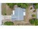 Aerial view of a house with gray roof, driveway, and landscaping at 1018 E Gaucho Cir, Deltona, FL 32725