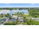 Expansive lakefront property with lush greenery and mature trees offers serene views and privacy at 1018 E Gaucho Cir, Deltona, FL 32725