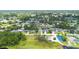 Neighborhood aerial view showcases lush landscaping and many residences near recreation areas at 1018 E Gaucho Cir, Deltona, FL 32725