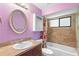 Well-lit bathroom with vanity, mirror, and tiled shower/tub combo at 1018 E Gaucho Cir, Deltona, FL 32725
