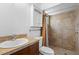 Bathroom featuring a sink, toilet, storage cabinet, and tiled shower with curtain at 1018 E Gaucho Cir, Deltona, FL 32725