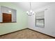Bright dining area features a modern chandelier and a large window, perfect for Gathering meals at 1018 E Gaucho Cir, Deltona, FL 32725