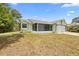 Charming single-story home featuring a two-car garage and a screened-in porch at 1018 E Gaucho Cir, Deltona, FL 32725