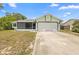 Charming single-story home featuring a two-car garage and a screened-in porch at 1018 E Gaucho Cir, Deltona, FL 32725