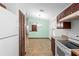Bright kitchen offers sleek countertops, dark wood cabinets, white appliances, and an open view to the dining area at 1018 E Gaucho Cir, Deltona, FL 32725