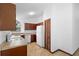 Traditional kitchen featuring white appliances, dark cabinets, and tile floors at 1018 E Gaucho Cir, Deltona, FL 32725
