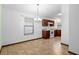 Bright dining area featuring a modern chandelier, seamlessly connecting to a kitchen with sleek appliances at 1018 E Gaucho Cir, Deltona, FL 32725