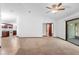 Spacious living room with carpet and adjacent kitchen featuring modern appliances at 1018 E Gaucho Cir, Deltona, FL 32725