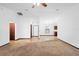 Open-concept living space with neutral tones, tile flooring, and a view of the front entrance at 1018 E Gaucho Cir, Deltona, FL 32725