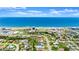 Breathtaking aerial view capturing the community, the beach and the ocean with blue skies and clouds above at 1027 Bel Aire Dr, Daytona Beach, FL 32118