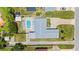 Aerial view showcases a home with backyard pool, well-maintained landscaping, and a long driveway at 1027 Bel Aire Dr, Daytona Beach, FL 32118
