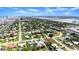 Expansive aerial shot showcasing a quaint neighborhood near a serene bay, complete with lush trees and a picturesque bridge at 1027 Bel Aire Dr, Daytona Beach, FL 32118