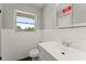 This bathroom features tile and a vanity with drawer and cabinet storage at 1027 Bel Aire Dr, Daytona Beach, FL 32118