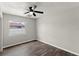 Cozy bedroom with gray wood floors, neutral walls, and a ceiling fan at 1027 Bel Aire Dr, Daytona Beach, FL 32118